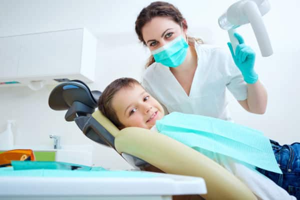 Pediatric dentist with child patient